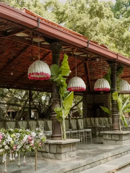The guest seating area at the wedding, with large woven lampshades hanging from the ceiling.