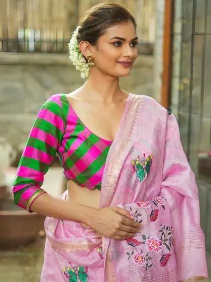 The same pink and green checkered blouse, demonstrating its versatility by pairing it with another beautiful pink saree.