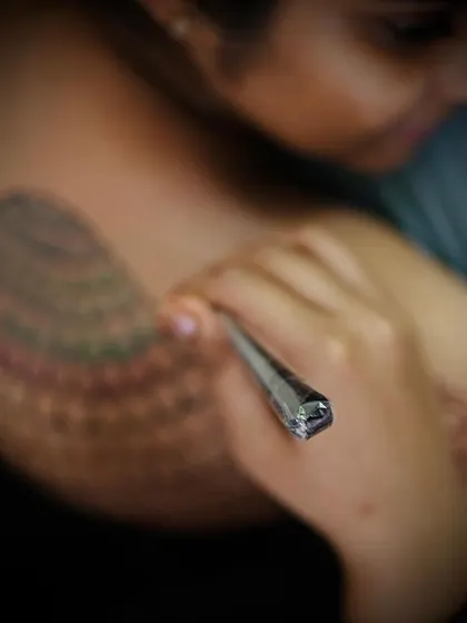 A focused shot of the henna cone as I apply the colored paste. I always use high quality, skin safe products for all my creative henna work.