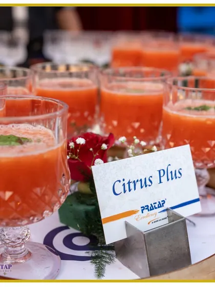 A tray of our "Citrus Plus" mocktail, a tangy and refreshing fruit drink garnished with a mint leaf, served in elegant cut-glass tumblers.