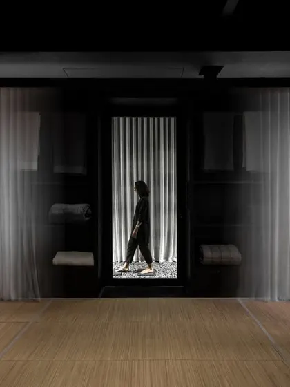 Our design for the Bonnie & Saks flagship store begins with an atmospheric entry. We use dramatic, sheer curtains and a monochromatic palette to create a sense of mystery and transition, inviting visitors to leave the everyday behind and enter a more contemplative retail environment.