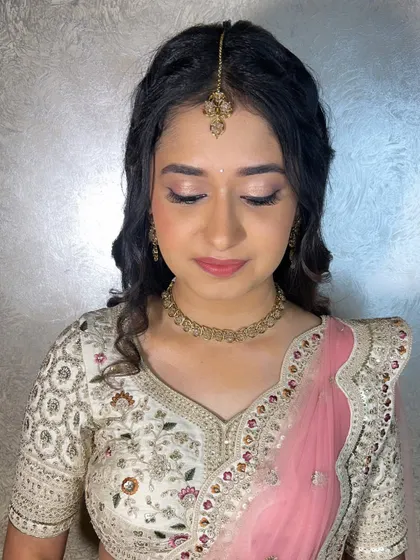 A close-up of Shreya's engagement makeup. You can see the delicate shimmer on the eyelids and the flawless, dewy finish of the skin.