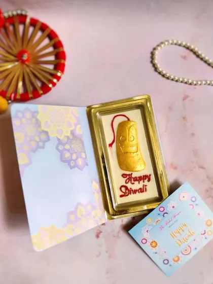 A unique twist on a classic Diwali gift. This is my chocolate bar book, which opens to reveal a beautiful, themed white chocolate bar wishing a "Happy Diwali." It's a sweet card and treat all in one.