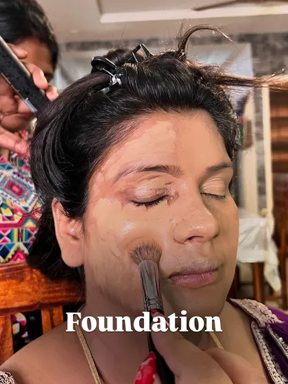 Applying the foundation. I use a brush to evenly distribute the product, ensuring full coverage that still looks natural and skin-like.