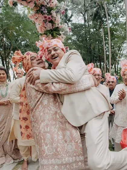 A heartwarming and energetic hug between family members during the celebration. These candid moments of love and connection are what make a wedding memorable.