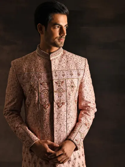 This is a menswear look I styled for a wedding couture campaign. The intricate embroidery on this blush pink sherwani is the hero, showcasing luxury craftsmanship in men's Indian formal wear.