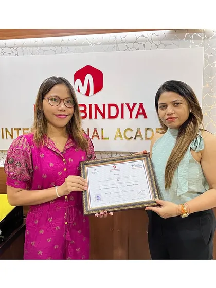 A proud graduate from a diverse background, ready to take her skills back to her community.