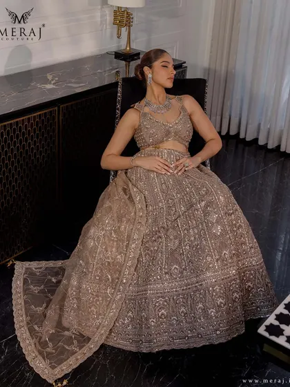 Timeless elegance designed for the modern bride. This stunning beige lehenga from the 'Ruvaah' collection is a masterpiece of hand-embellished embroidery.