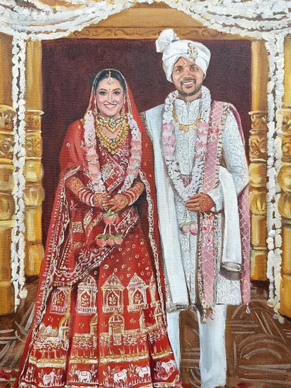 A close-up of the finished portrait from the live wedding painting in Raipur. The intricate details of the bride's red lehenga and the groom's sherwani are highlighted.