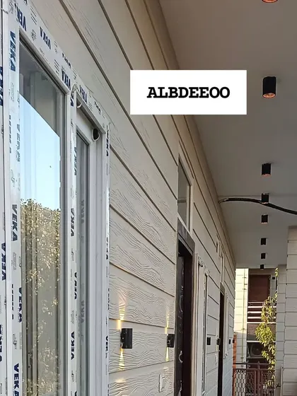 A series of detailed shots of a terrace prefab house's exterior. These images focus on the wood-textured cement plank elevation, modern ceiling lights, and high-quality VEKA window frames.