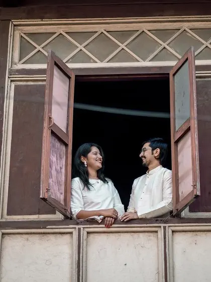 Looking out from a window of an old 'wada' or traditional house. This pose feels like a scene from a classic film, full of story and charm.