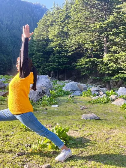 A beautiful shot of Virabhadrasana I (Warrior I) in nature. Yoga is a science of well-being, of youthfulness, of integrating body, mind, and soul.