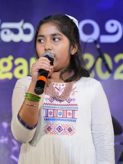Student Kyra Puri sings with passion during her duet performance at our annual show. We train students to perform with confidence and expression.