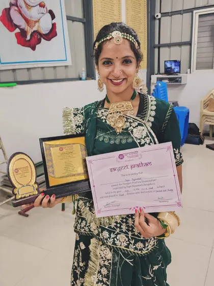 Holding my certificate and award, dressed in a traditional poshak. These moments of accomplishment are a blessing and a reminder of the beautiful path I am on.