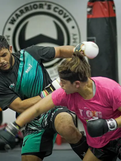 Our female fighters are just as tough as the men. Here, two athletes exchange punches in a technical sparring session, proving that skill has no gender.