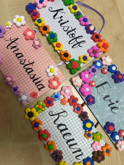 A collection of the finished clay flower nameplates. Each one is so unique and colourful, reflecting the personality of its creator.
