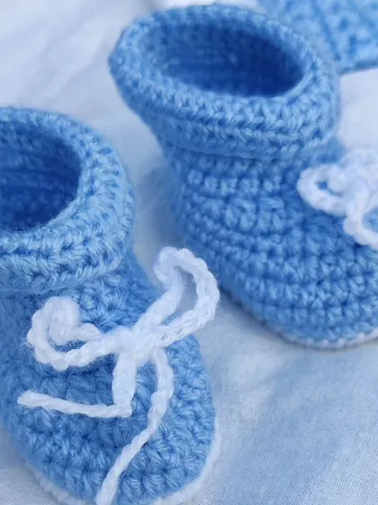 These tiny, hand-crocheted baby booties are part of my newborn set.