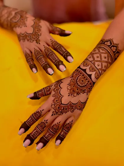 An artistic shot of the engagement mehendi, showing the design on both the front and back of one hand.