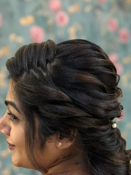 A side profile of a soft, textured half-updo. This is a very flattering and popular style that we cover in the course.