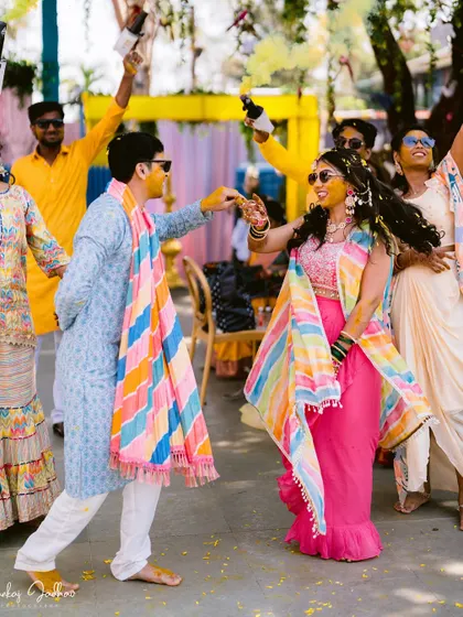 A candid moment of dance and joy between Laxmi and Roshan during their Haldi.