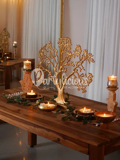 The warm glow of candlelight on a beautifully styled table sets the mood for any festive gathering. This setup features a golden tree console, creating a focal point that is both elegant and timeless.