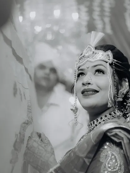 A timeless black and white portrait of the bride during the wedding ceremony. Her upward glance is full of hope and happiness, creating a deeply emotional and artistic image.