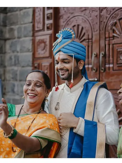 A heartwarming, candid moment of the groom taking a selfie with his mother and grandmother. These are the family memories to treasure.