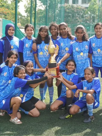 Our Women's Team proudly hoists the runners-up trophy. Every tournament is a chance to win or learn, and we are proud of their fighting spirit.