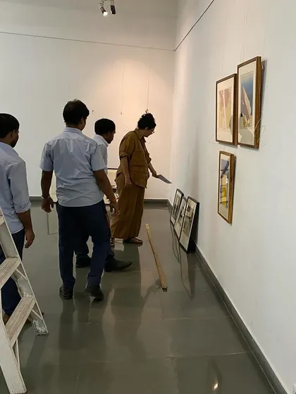 The team working on the lighting and final placement of artworks.