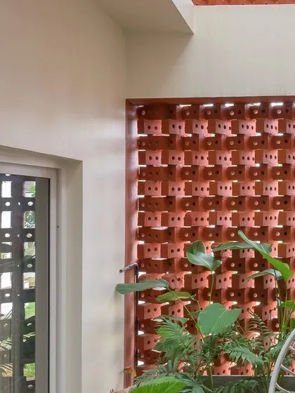 The brick screen allows light to pour into the balcony area while providing a sense of enclosure and privacy.