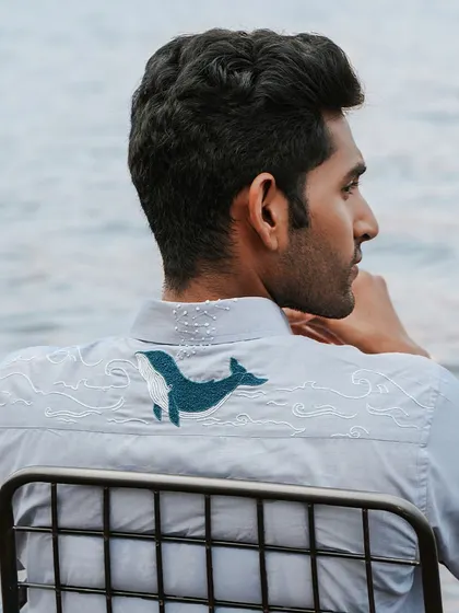 The 'Soaring Whale' shirt, featuring a hand-embroidered whale on the back. This design took 16 hours of artistry, creating a magical piece that cannot be replicated by a machine.