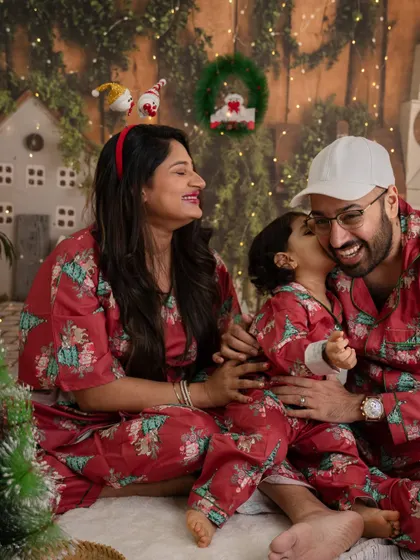 A candid moment of love and laughter from a previous year's Christmas mini session, with the family dressed in matching pajamas.