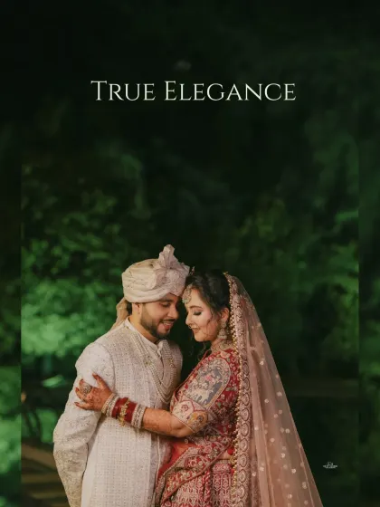 True elegance in a single frame. This intimate portrait captures the couple in a close embrace, set against a dark, natural background for a dramatic effect.