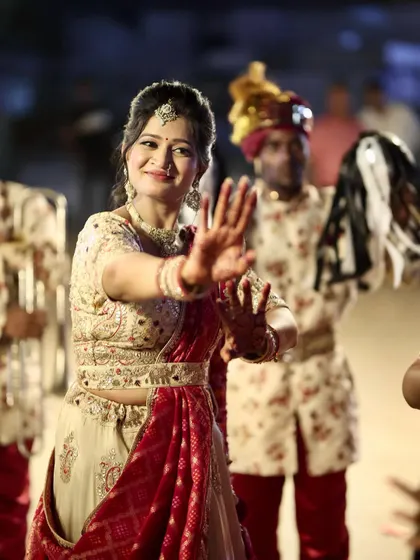 A happy, dancing shot of the guest, her joy evident as she participates in the baraat.