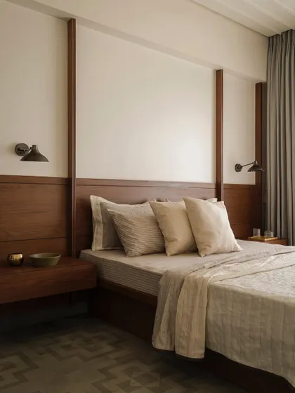 A bedroom in Apartment 1005, where we used wood paneling to create a warm and inviting backdrop. The design is simple and uncluttered, with a focus on natural materials and textures.