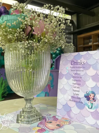 For a 'Mermaid' party, I designed custom menus and placemats with iridescent colors and mermaid graphics.
