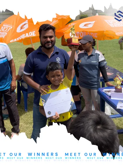 A young player proudly holds his trophy and certificate alongside his coach. These moments of recognition are crucial for building a young athlete's confidence and love for the game.