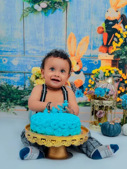 Nothing says "Happy First Birthday" like a cake smash! We love capturing the pure joy and delightful mess as your little one dives into their first cake. This is a memory full of laughter.