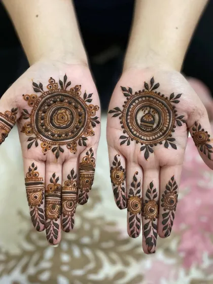 A lovely mandala design with personalized touches. One hand features a rose in the center, while the other has a small dome motif.