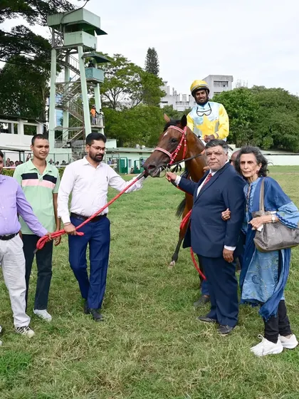 Maana, with jockey S. Antony Raj, is pictured with the winning team after a great performance.