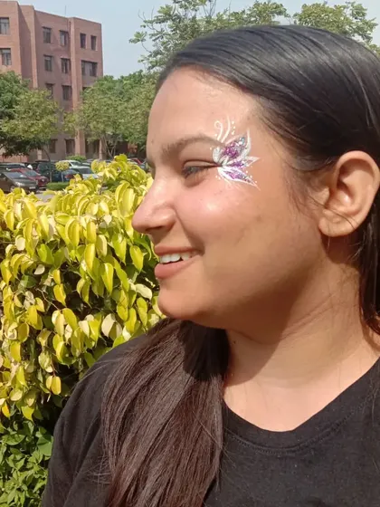 A pretty purple and white butterfly design, perfect for adding a bit of sparkle to your day at a college fest.