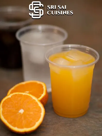 A classic Orange Cooler, made with fresh orange juice and served over ice. It's a timeless and popular choice for a welcome drink station at any event, from weddings to corporate functions.