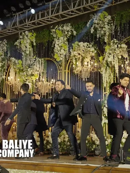 Another dynamic shot of the groomsmen's performance, showcasing their synchronized moves and the grand scale of the stage production.