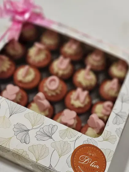 A beautifully packaged box of our custom whole wheat red velvet cupcakes, tied with a pink ribbon and ready for gifting.