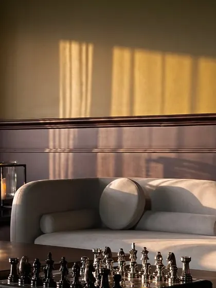 The way light falls in a room is one of my obsessions. This moment captures the warm evening sun highlighting the textures of the sofa and the rich teak wood, creating a quiet, contemplative mood that I strive for in my designs.