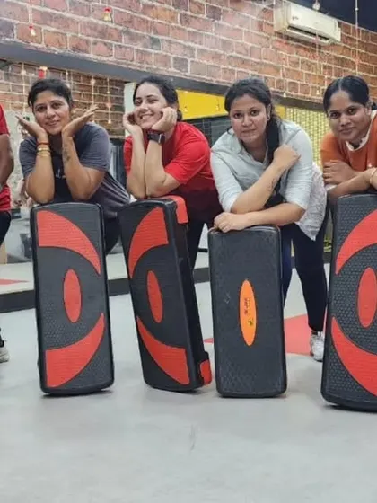 Taking a quick break after a tough step aerobics session. This workout is great for cardiovascular fitness and lower body toning, using simple equipment for a high-impact class.