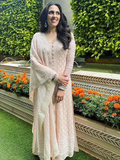 A lovely candid moment in a beautiful chikankari anarkali by Abu Jani Sandeep Khosla. This look is all about effortless grace and traditional craftsmanship.