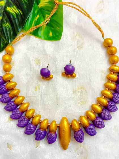 The sleek choker in a rich purple and gold.