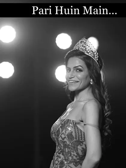 A dramatic black and white shot from a beauty pageant. The title "Pari Huin Main" (I've become a fairy) perfectly captures the magical feeling of being on stage.
