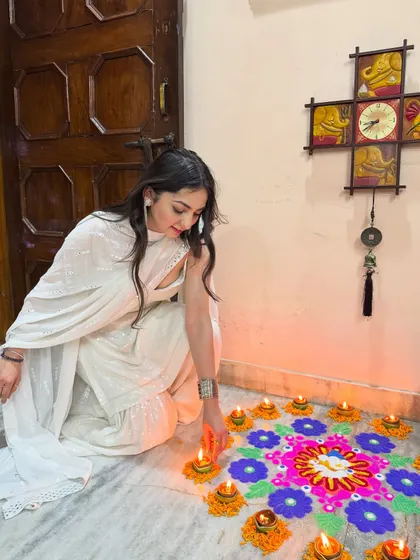 Manifesting all the good vibes this Diwali. A serene moment lighting diyas in a beautiful all-white sharara set, embracing the festive spirit.